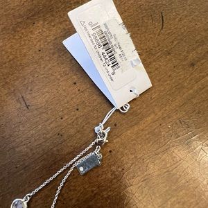 Kate Spade “Opening Night” silver & crystal necklace. App 39” long. New w tags